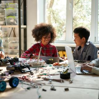 picture of young students assembling a model vehicle